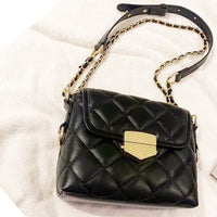 Black, pu leather, quilted messenger handbag with gold buckle and gold chain covered black strap. Square shape.